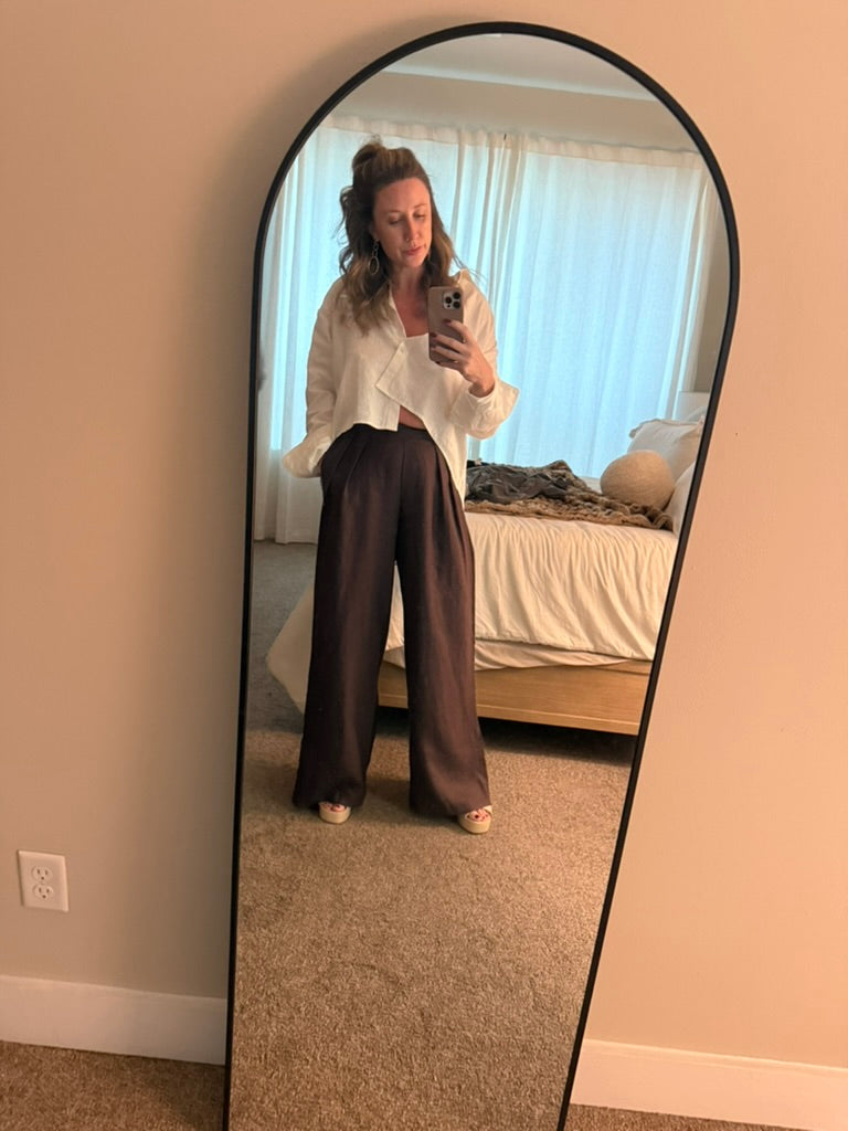 The Espresso Trouser on a hanger beside the Bone Button Up Crop, showing the linen texture