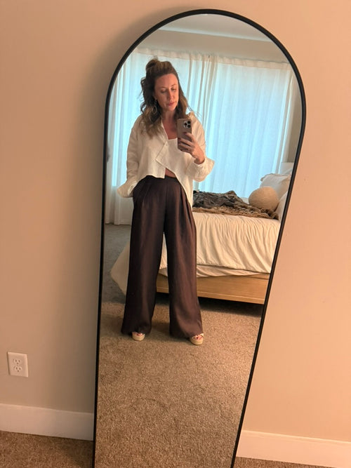 The Espresso Trouser on a hanger beside the Bone Button Up Crop, showing the linen texture