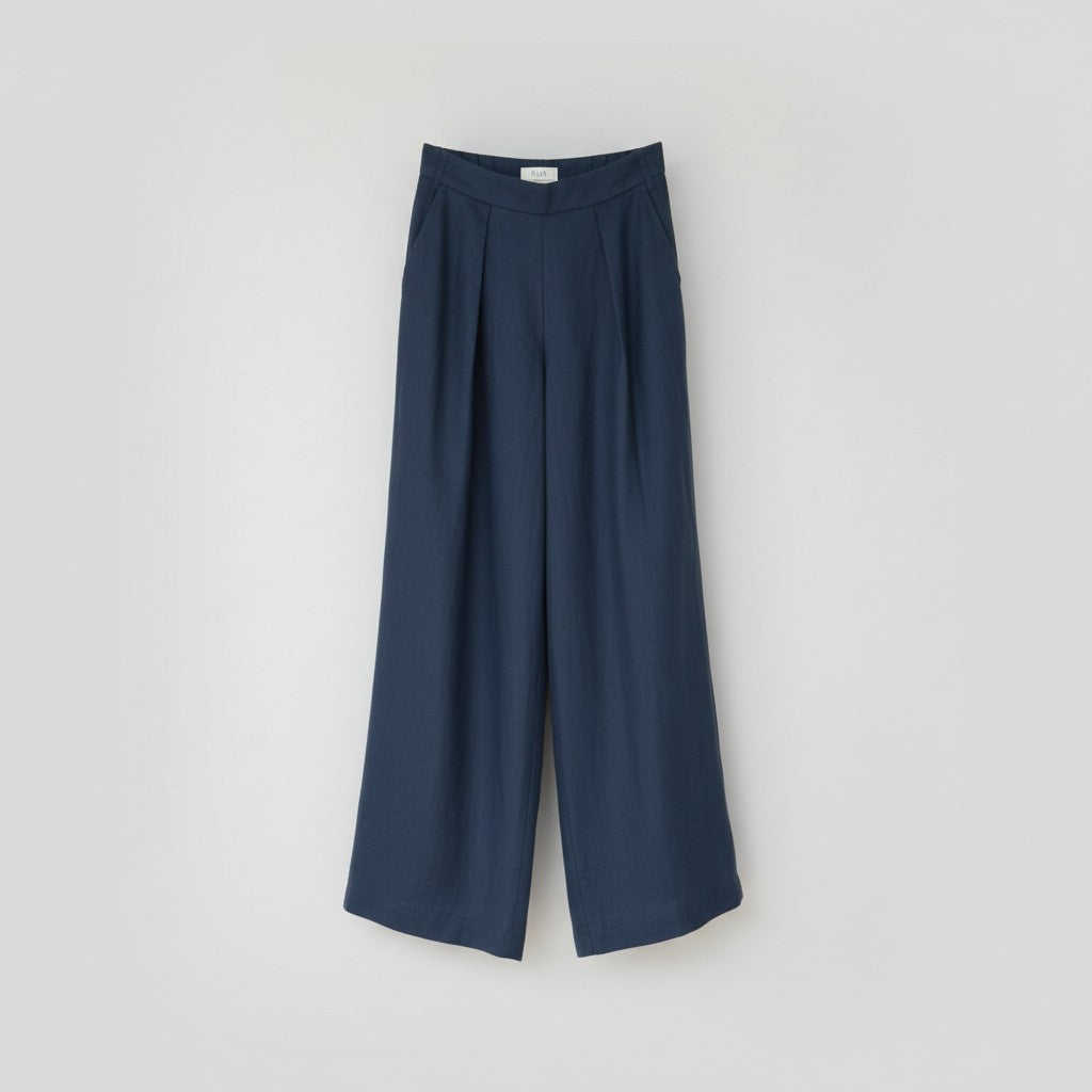 The Trouser in petrol linen, shown against a plain background