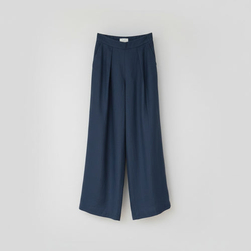 The Trouser in petrol linen, shown against a plain background
